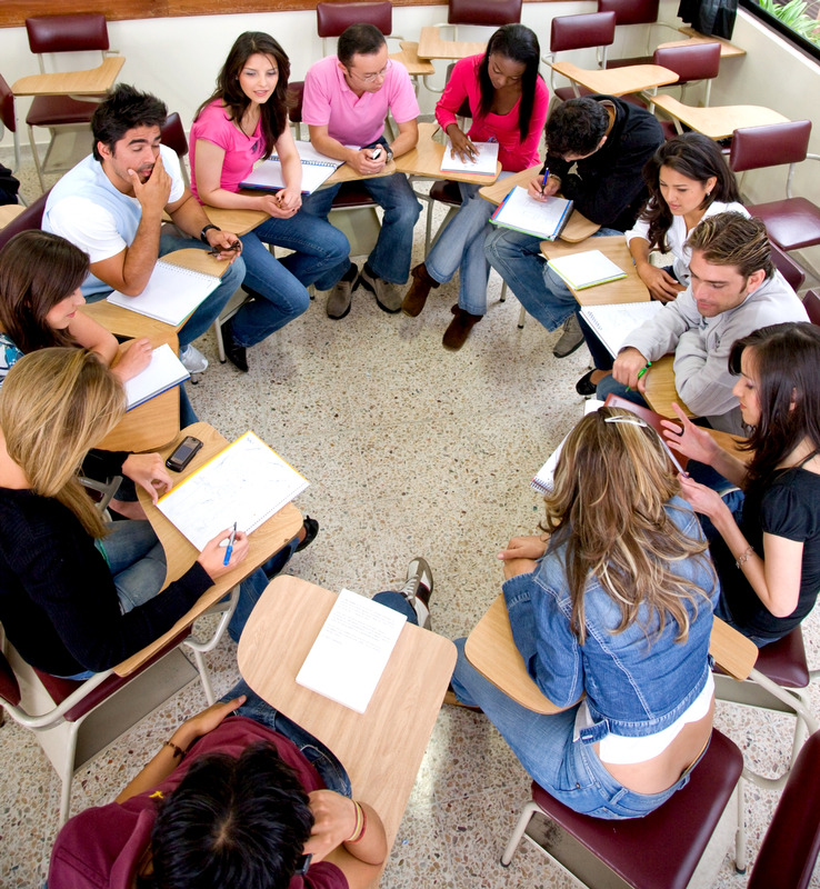 groups of students with desks in a circle